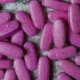 Close up view of purple-coated tablets