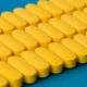 Close up view of yellow-coated tablets in rows