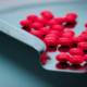 VIew of red-coated tablets in a perforated coating pan