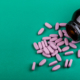 View of coated tablets spilled out of a medicine bottle